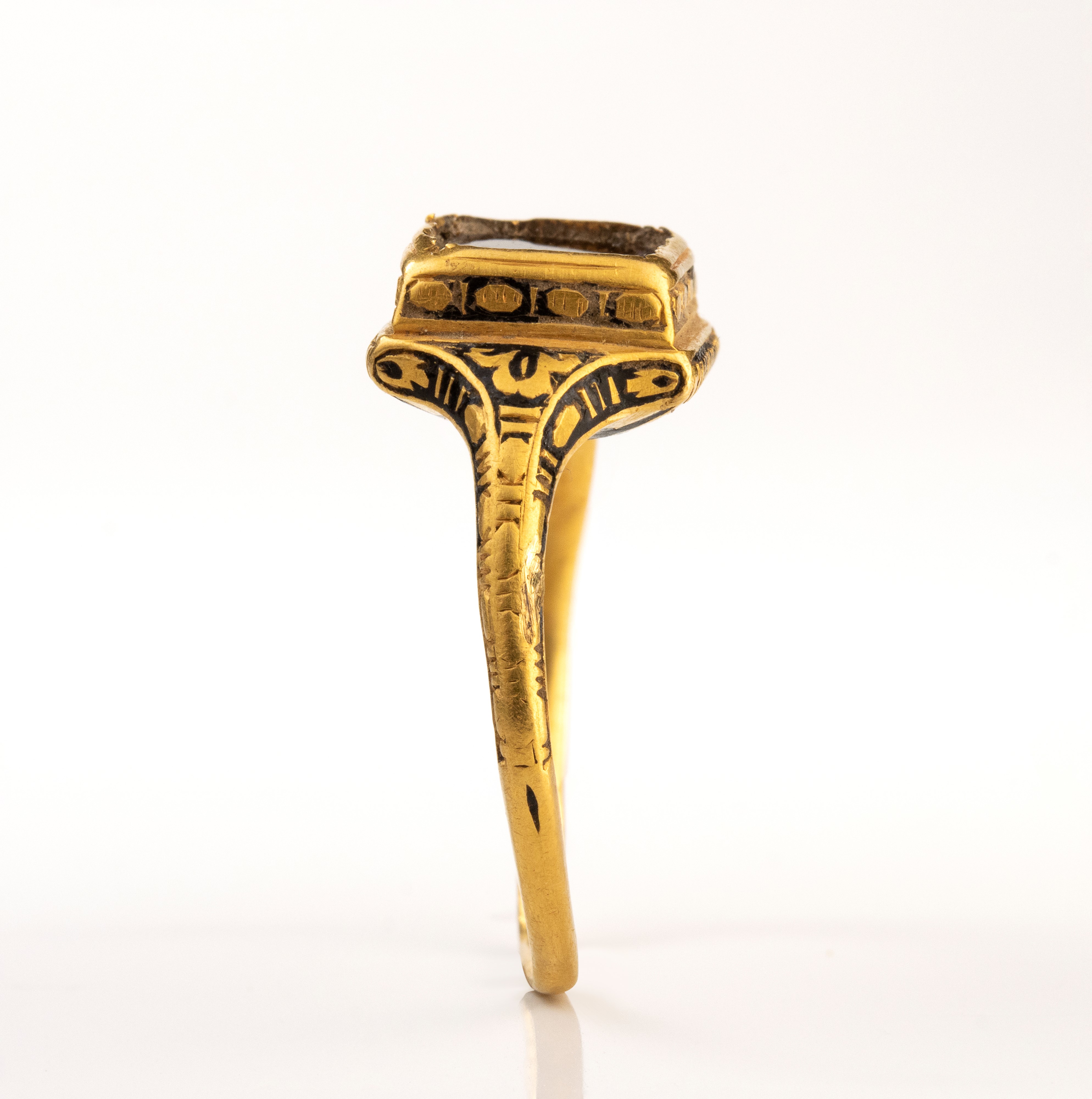 A Late Renaissanace gold and black enamel ring set with a garnet.