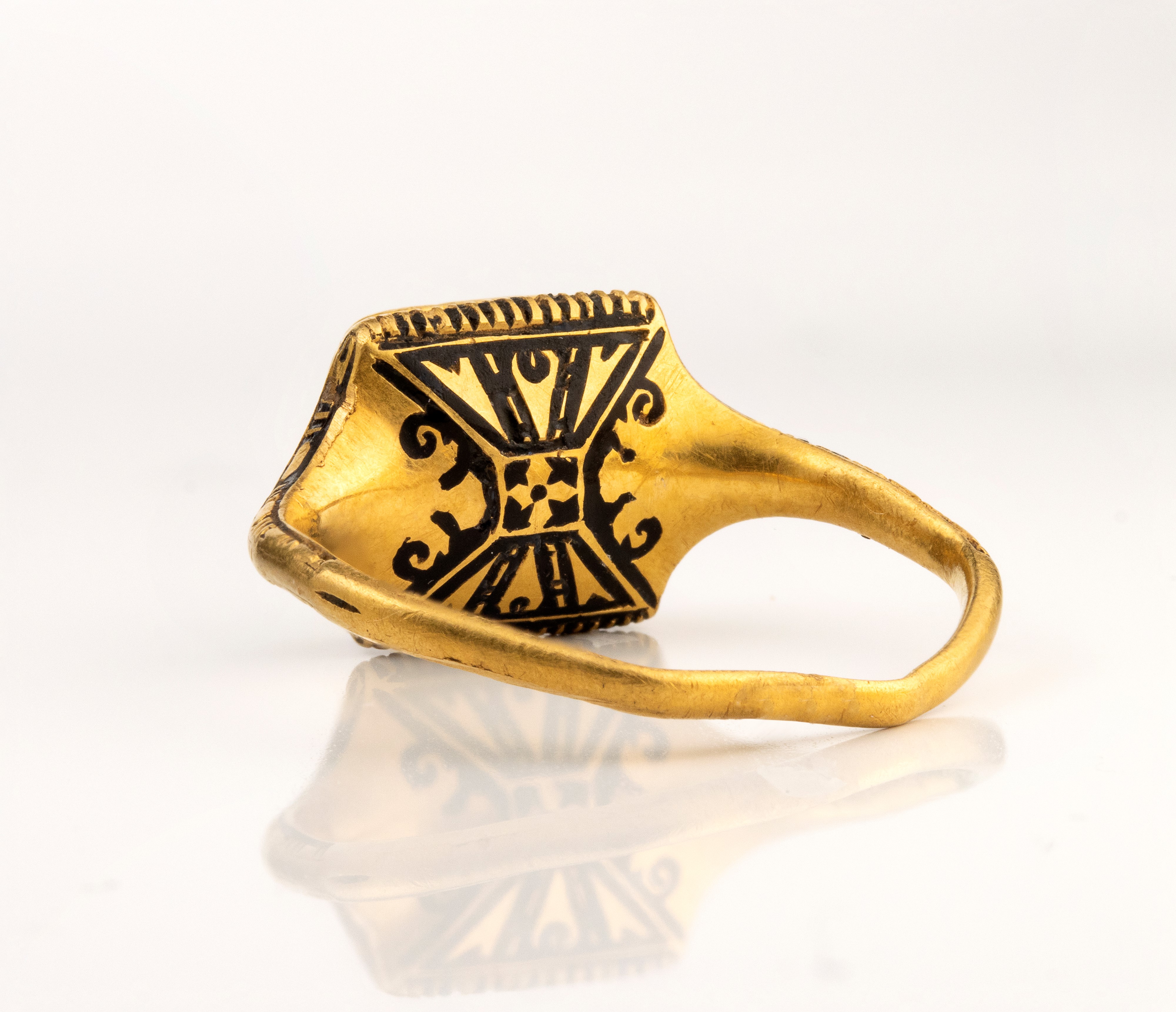 A Late Renaissanace gold and black enamel ring set with a garnet.