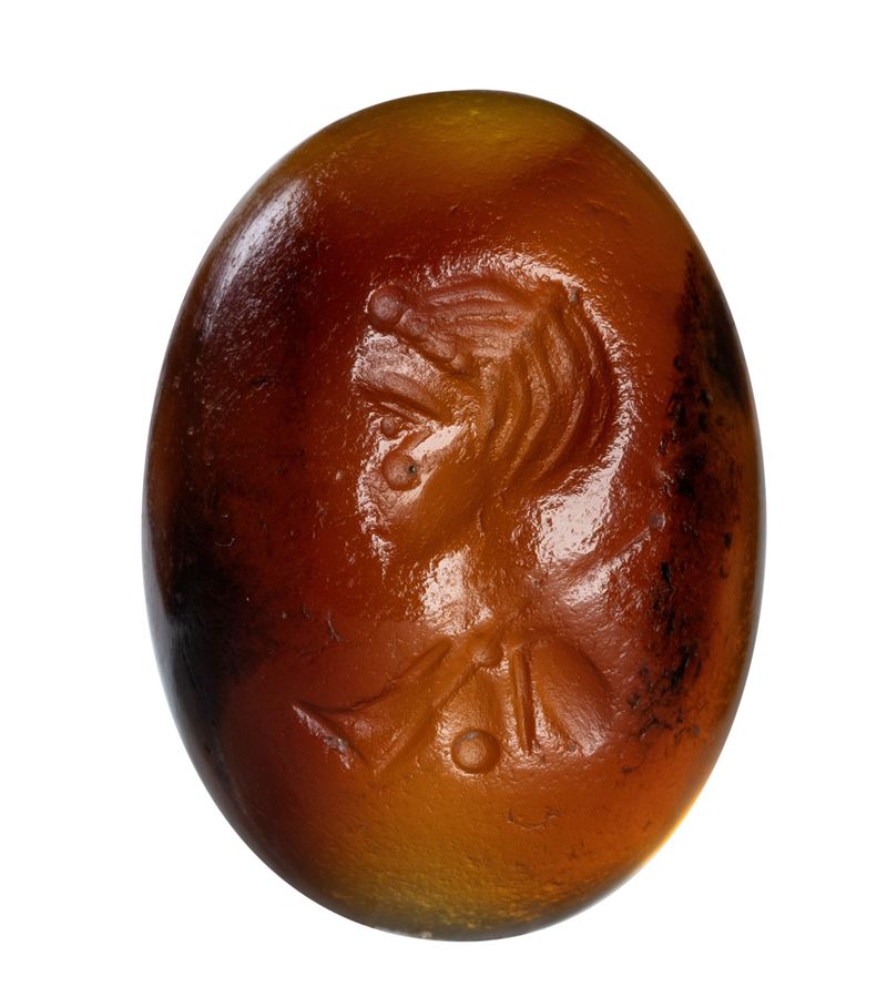 A Roman cabochon carnelian intaglio. Female bust.