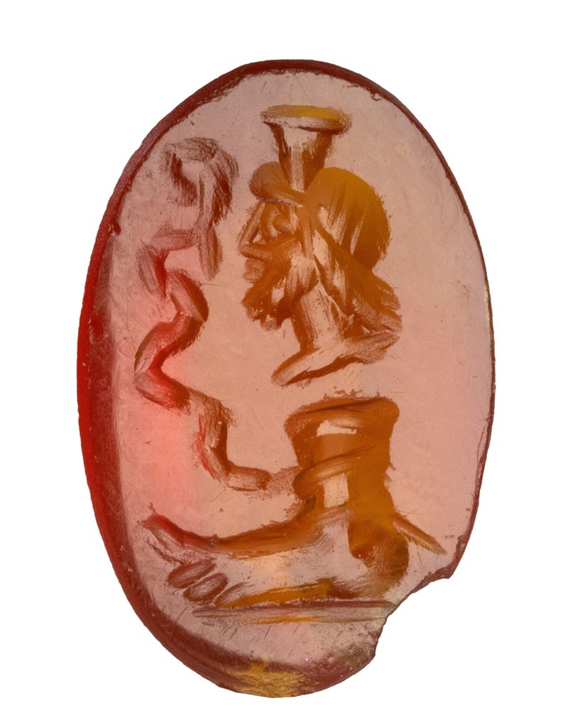 A Roman magical carnelian intaglio. Serapis with foot and snake.