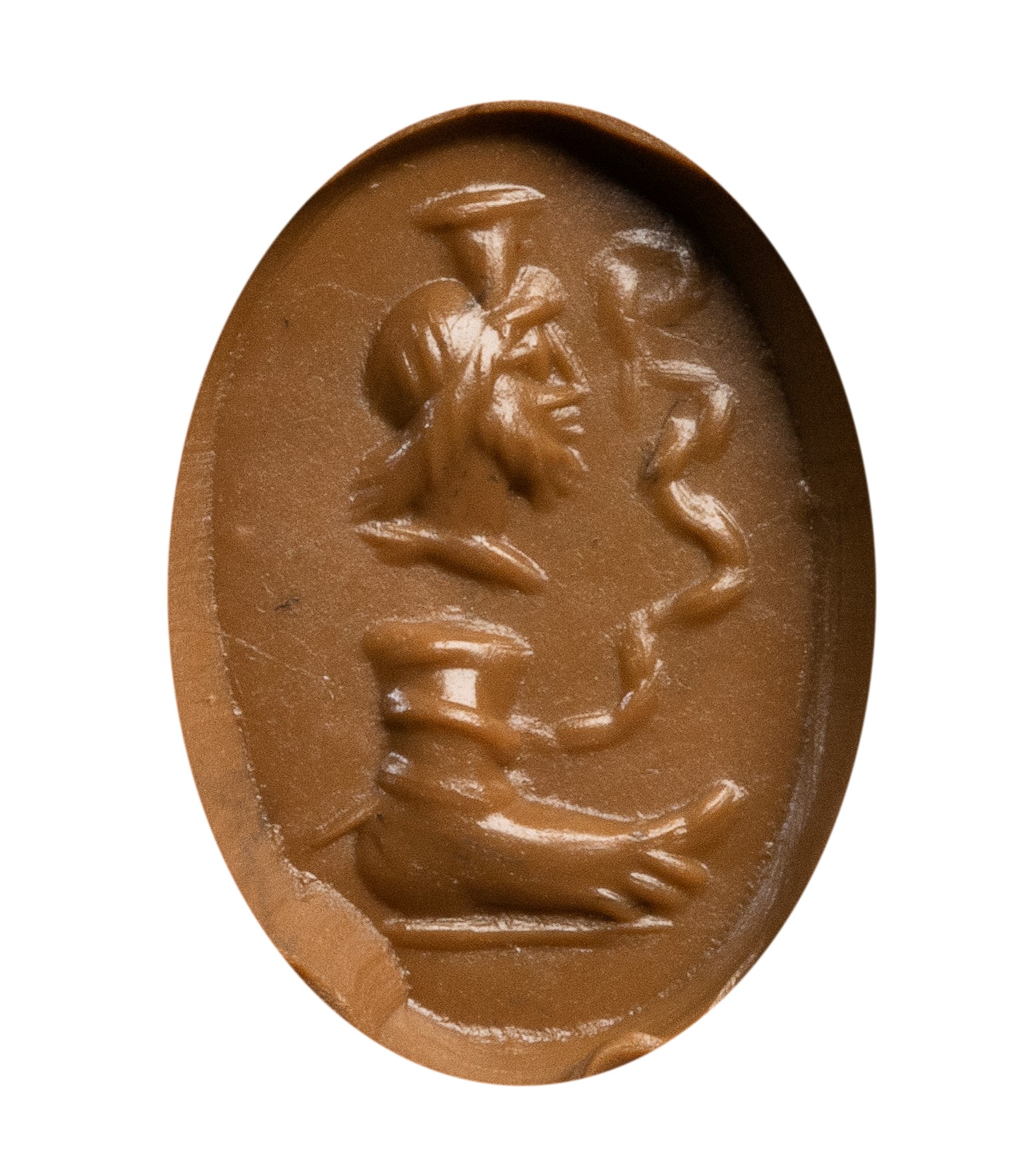 A Roman magical carnelian intaglio. Serapis with foot and snake.