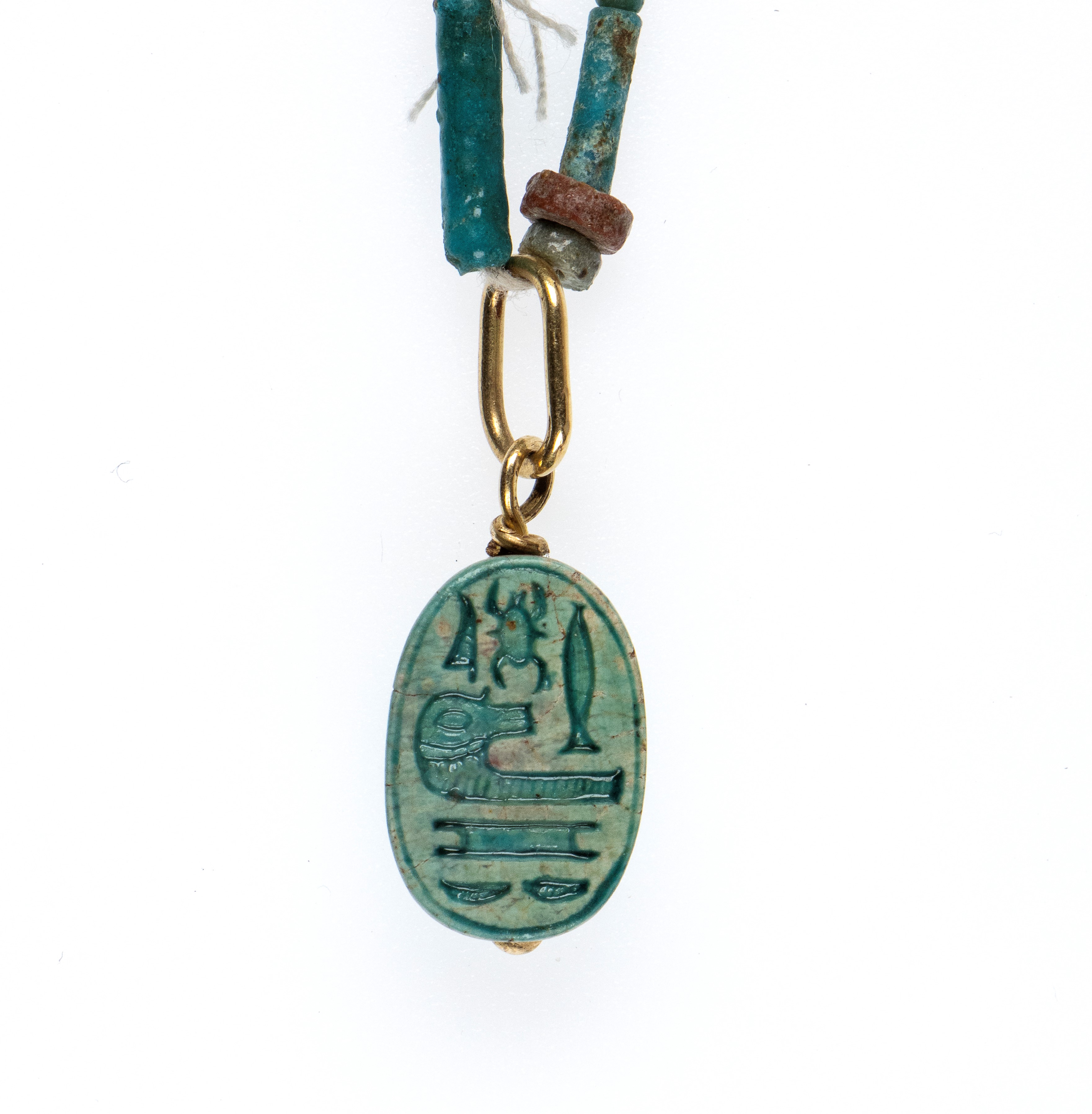 A Restrung New Kingdom faience necklace with an engraved scarab.