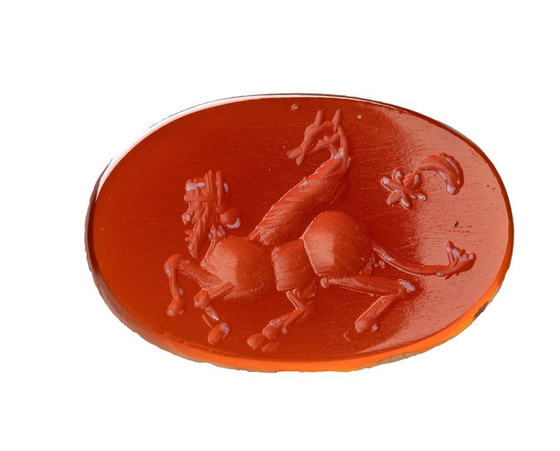 A Sasanian carnelian intaglio. Hybrid figure with attributes.