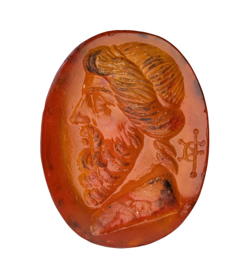 A Roman carnelian intaglio. Bust of an herm.