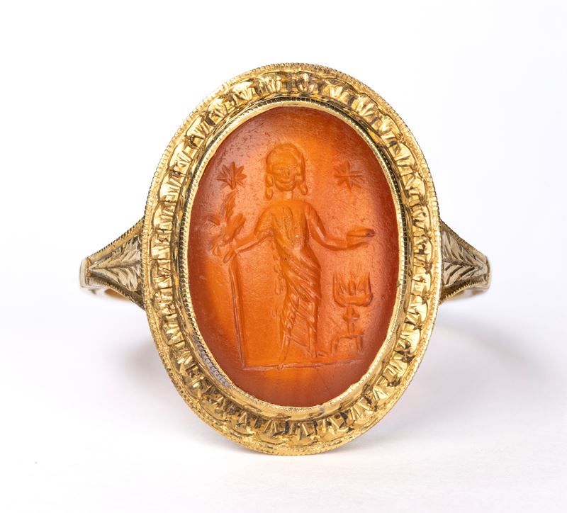 A Roman carnelian intaglio set in a later gold ring. Votive scene.