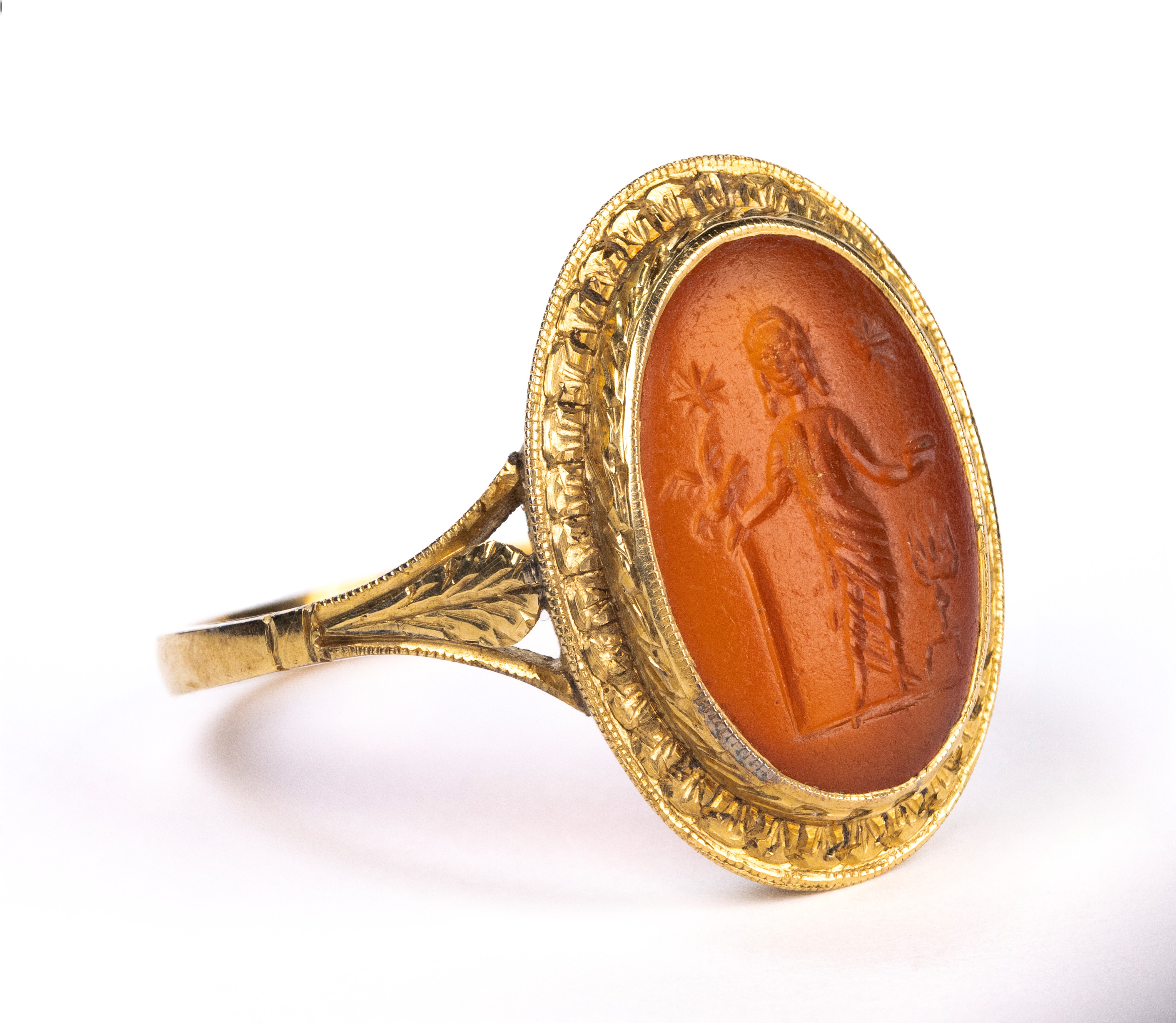 A Roman carnelian intaglio set in a later gold ring. Votive scene.