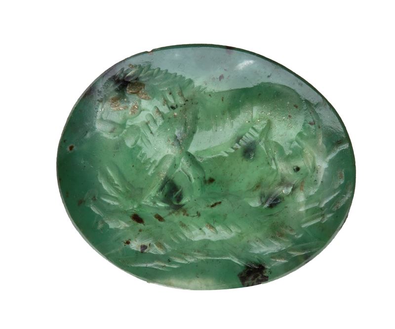 A Roman green chalcedony intaglio. Lion killing a boar.