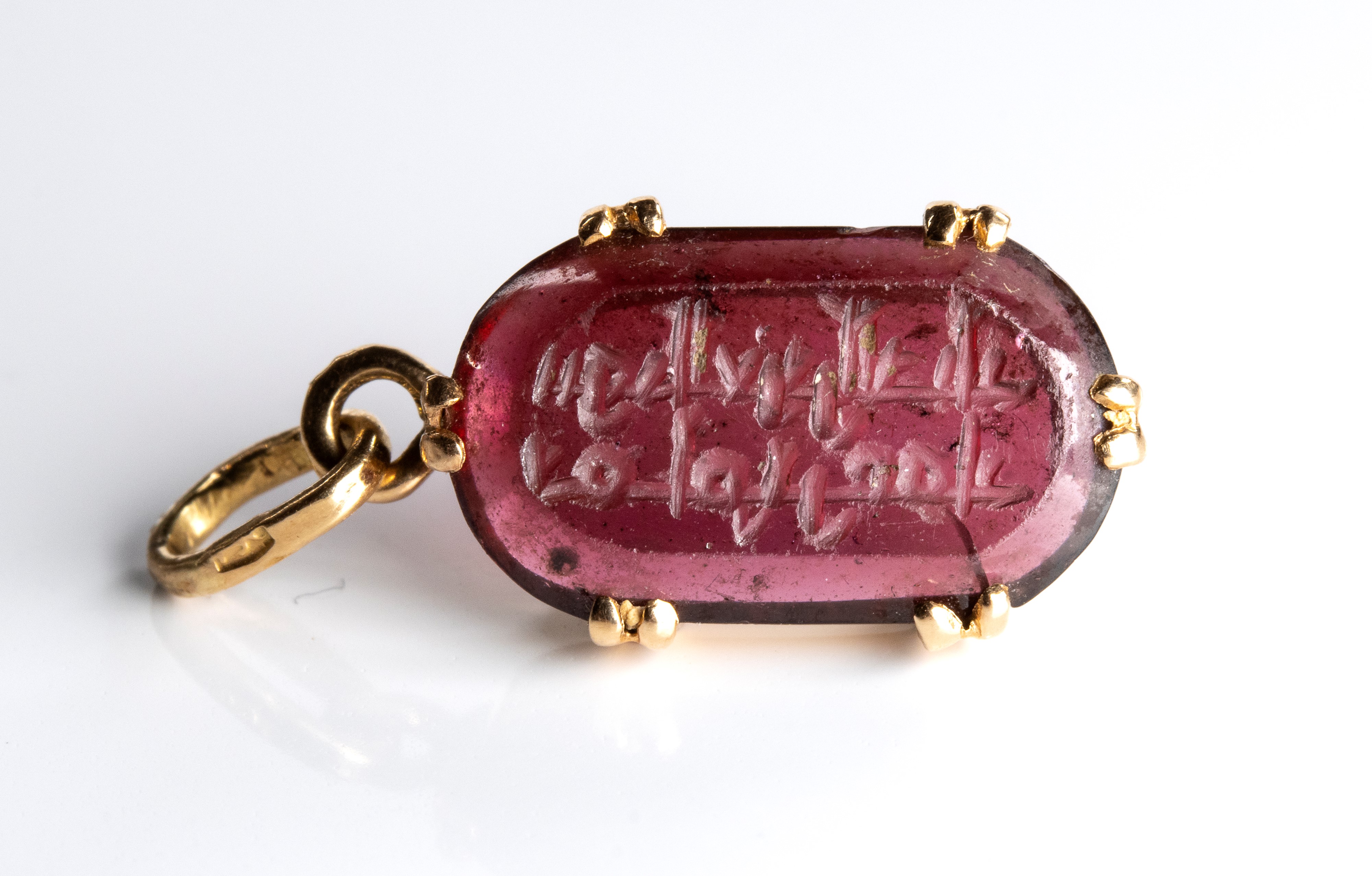 The Seal of the Emir 'Ammar. Tourmaline intaglio with Arabic inscription, set in a later gold pen...