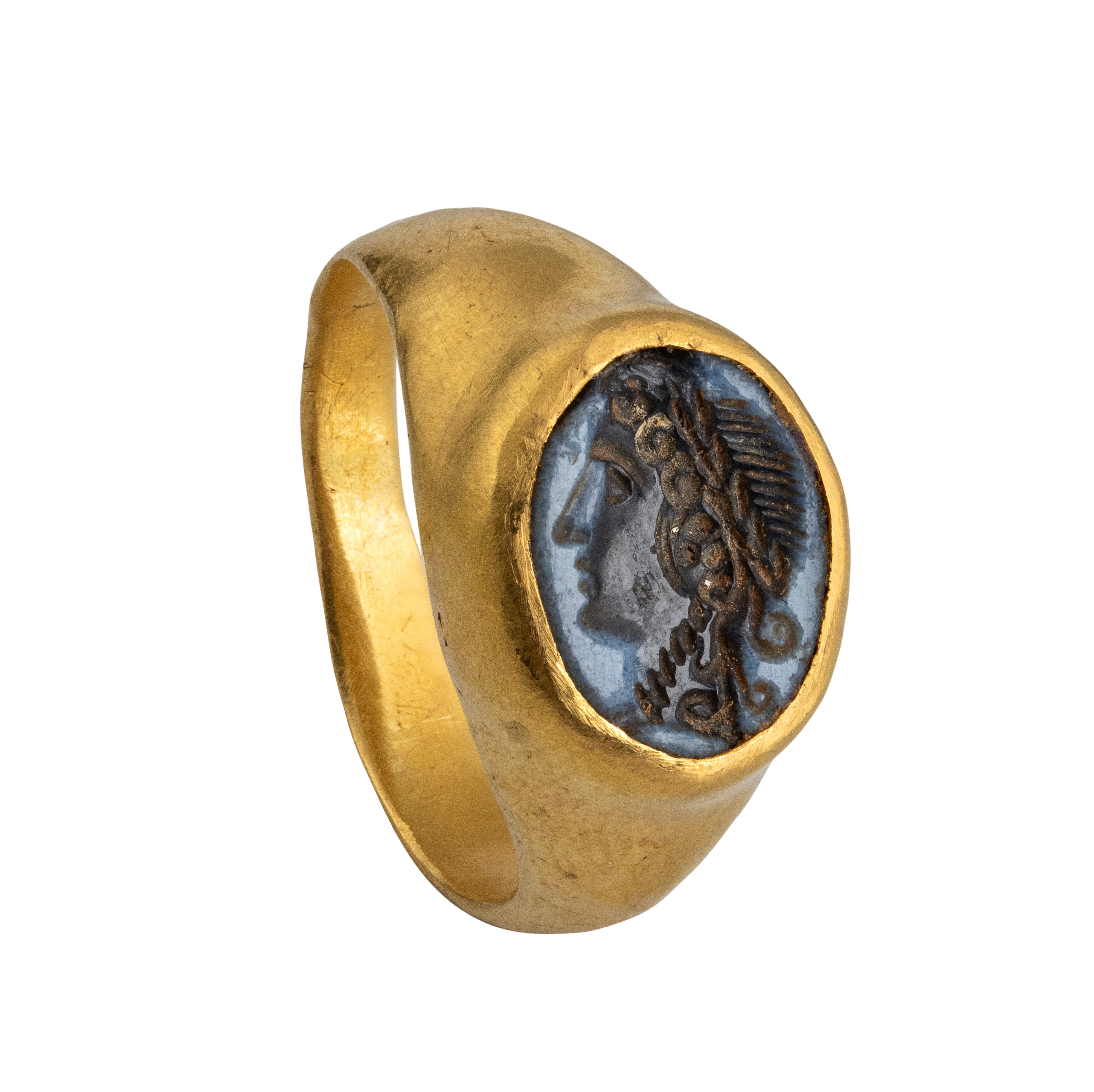 A Roman gold ring set with a nicolo intaglio. Head of Dyonisus.