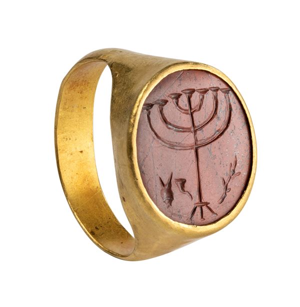 A Roman gold ring with a jasper intaglio. Menorah with attributes.