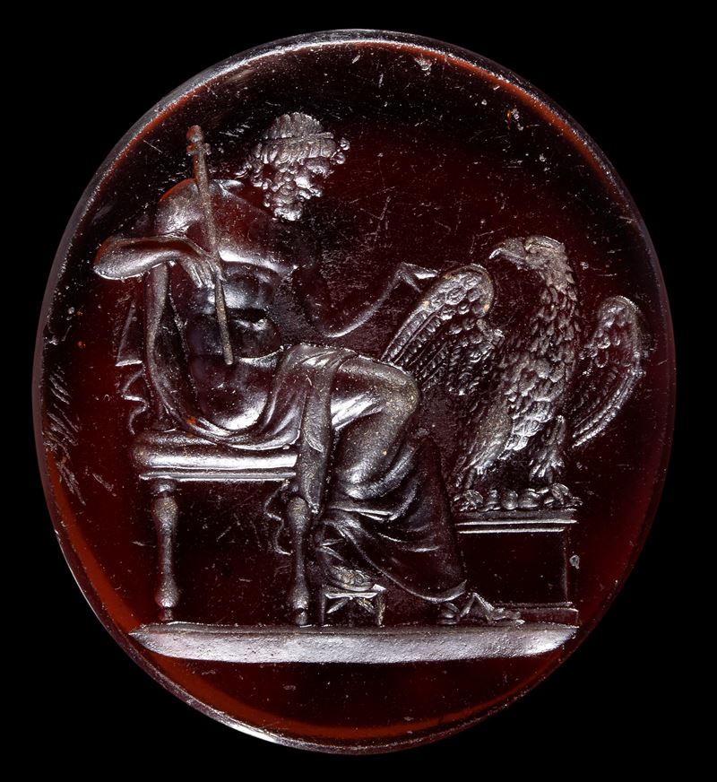 A large Grand Tour reddish brown glass cast impression. Jupiter sitting with the eagle.