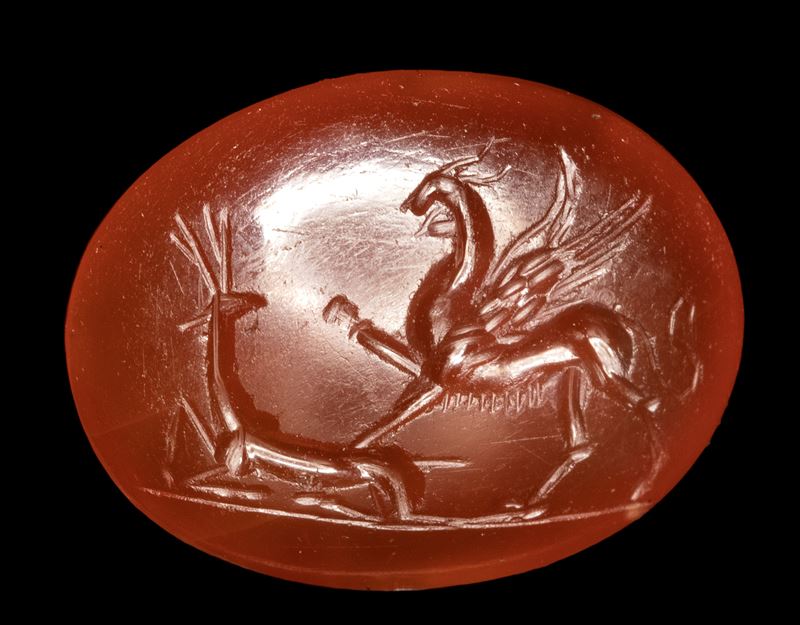 A Roman carnelian intaglio. Griffin with deer.
