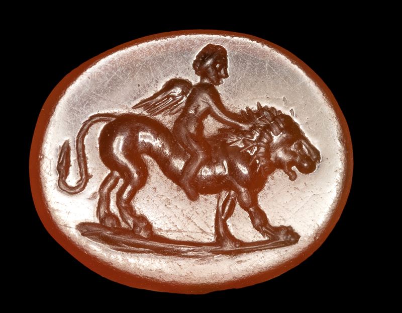 A Roman carnelian intaglio. Eros on a lion.