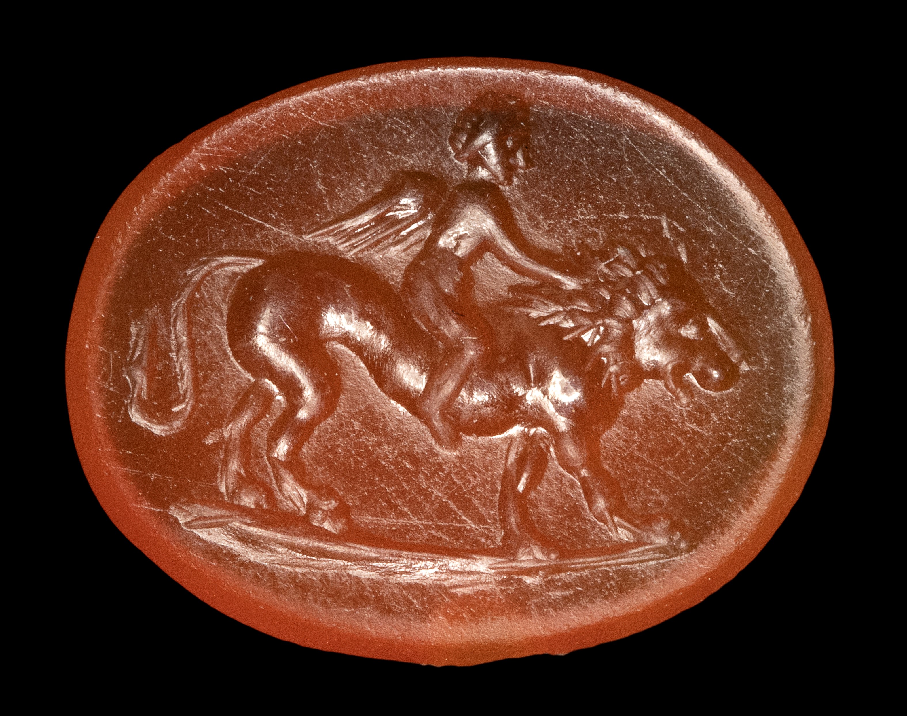 A Roman carnelian intaglio. Eros on a lion.