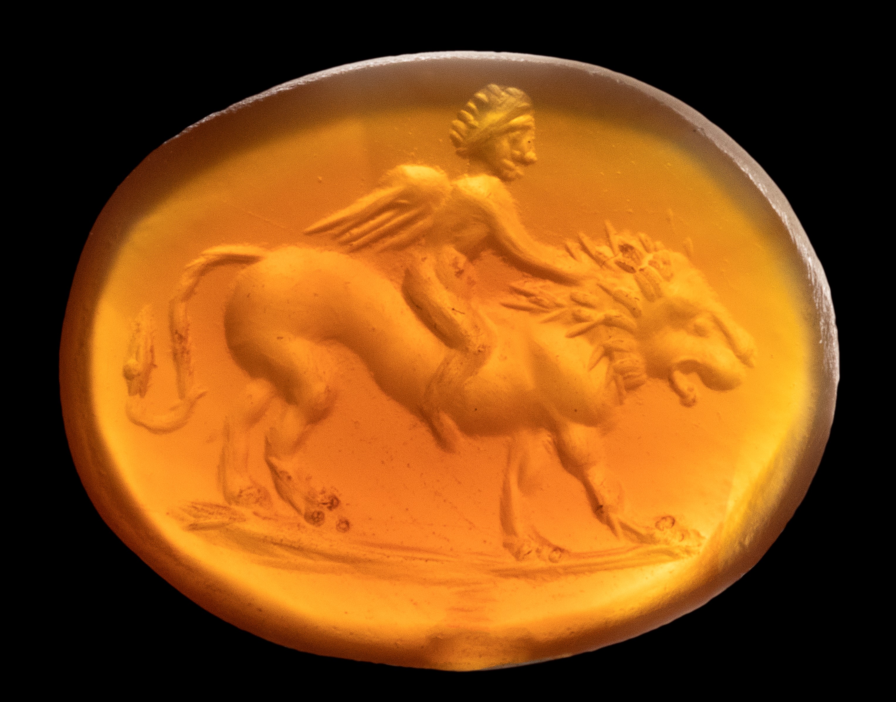 A Roman carnelian intaglio. Eros on a lion.