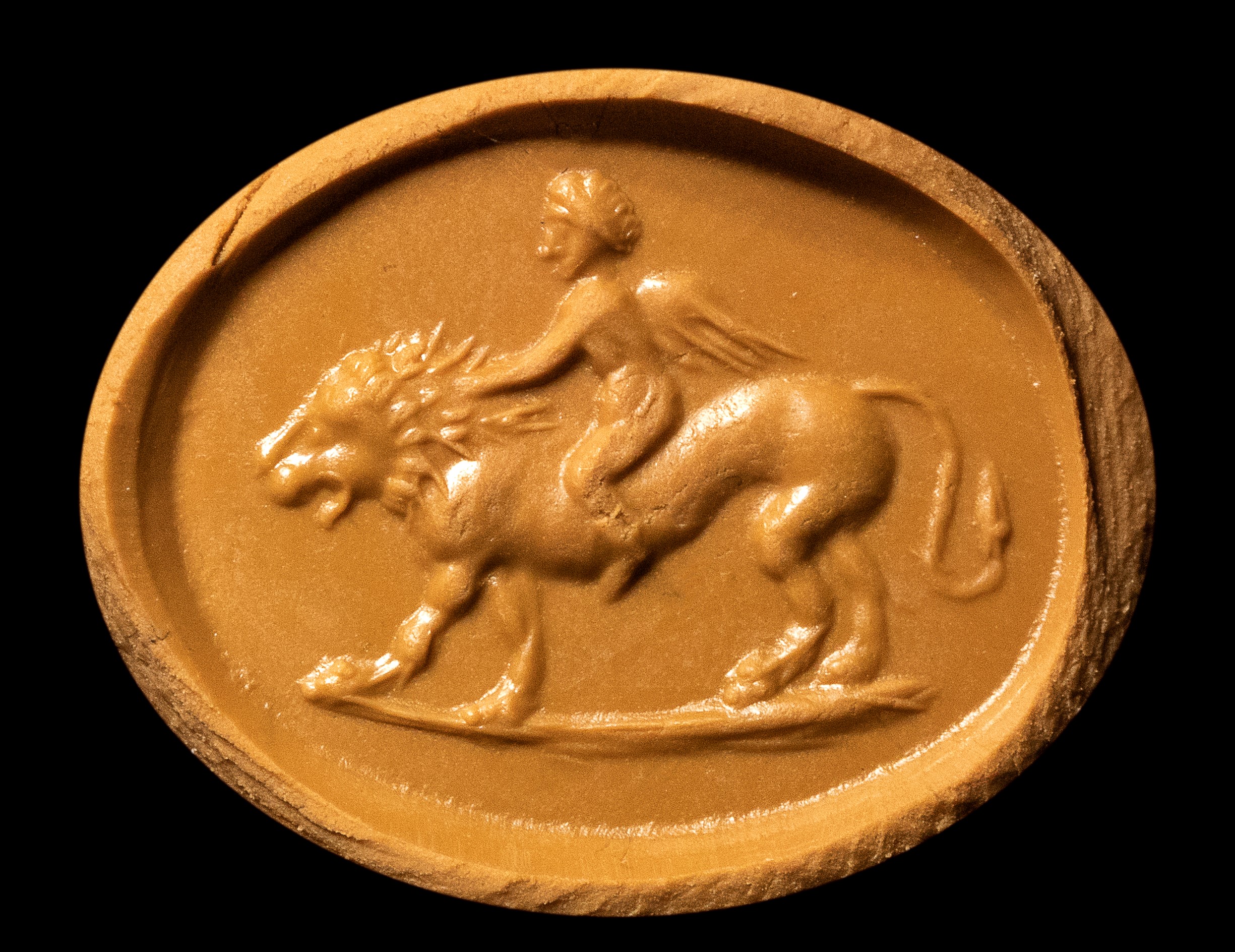 A Roman carnelian intaglio. Eros on a lion.