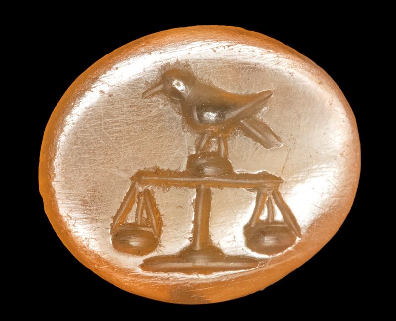 A Roman carnelian intaglio. Bird on a scale.