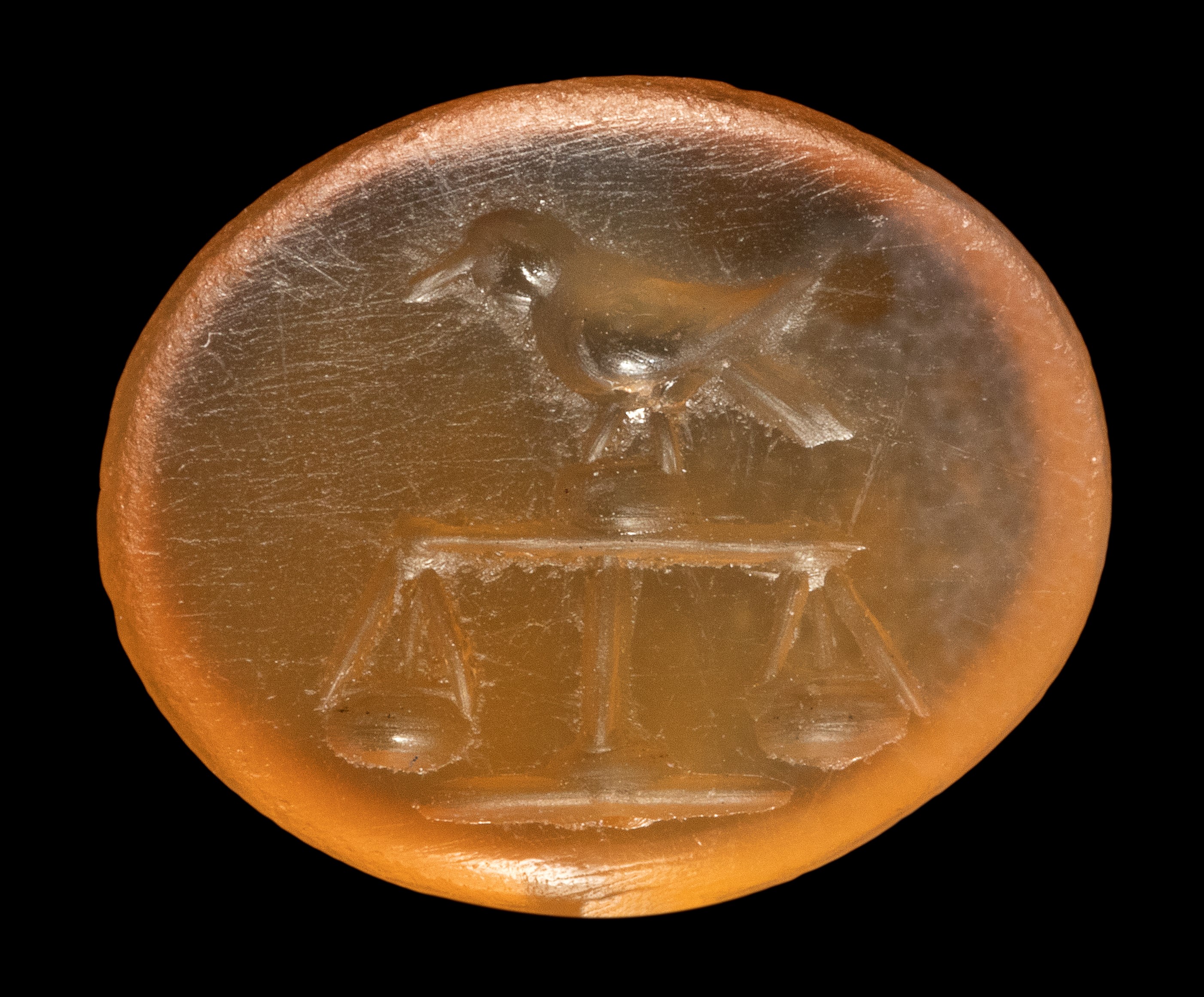 A Roman carnelian intaglio. Bird on a scale.
