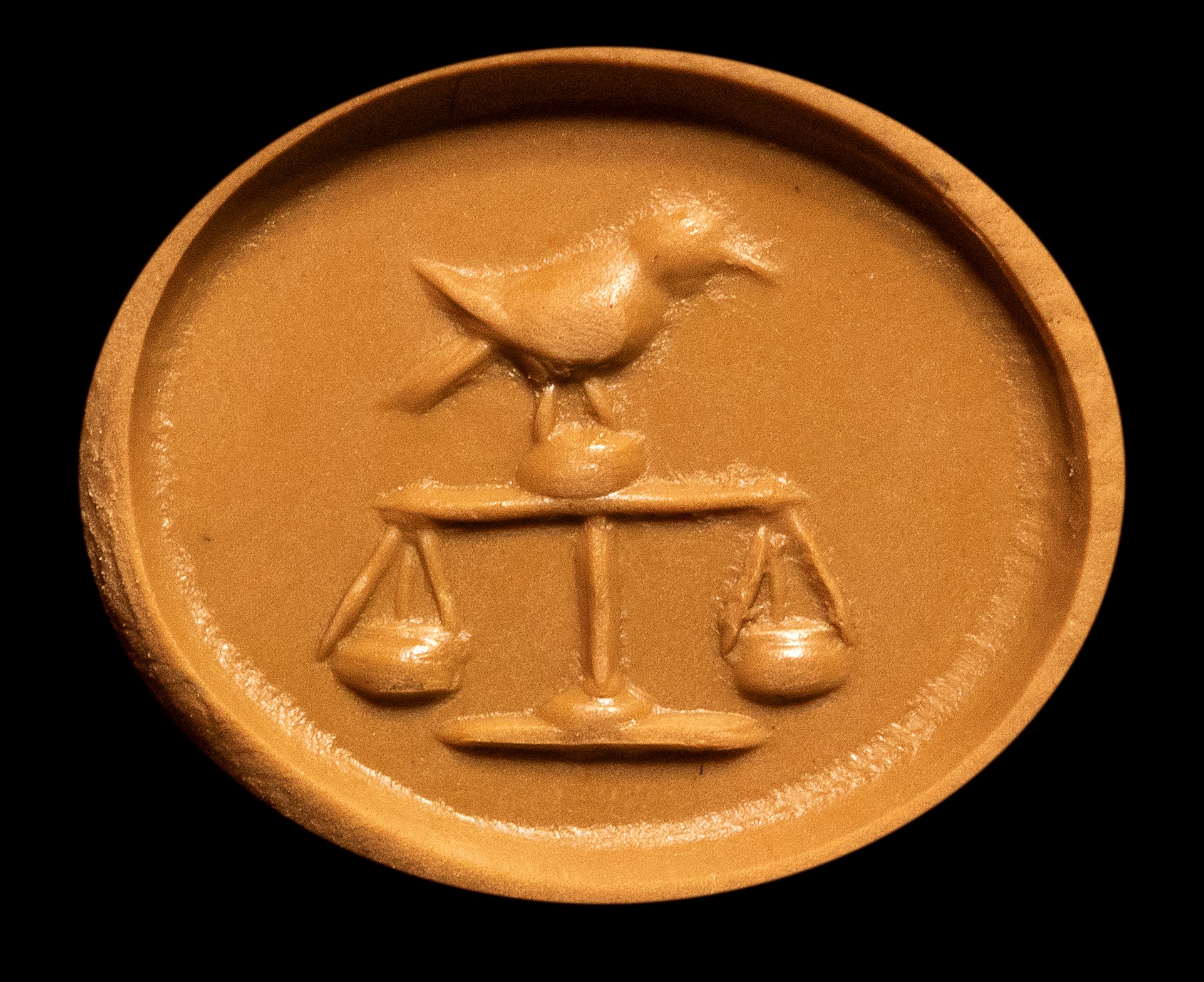 A Roman carnelian intaglio. Bird on a scale.