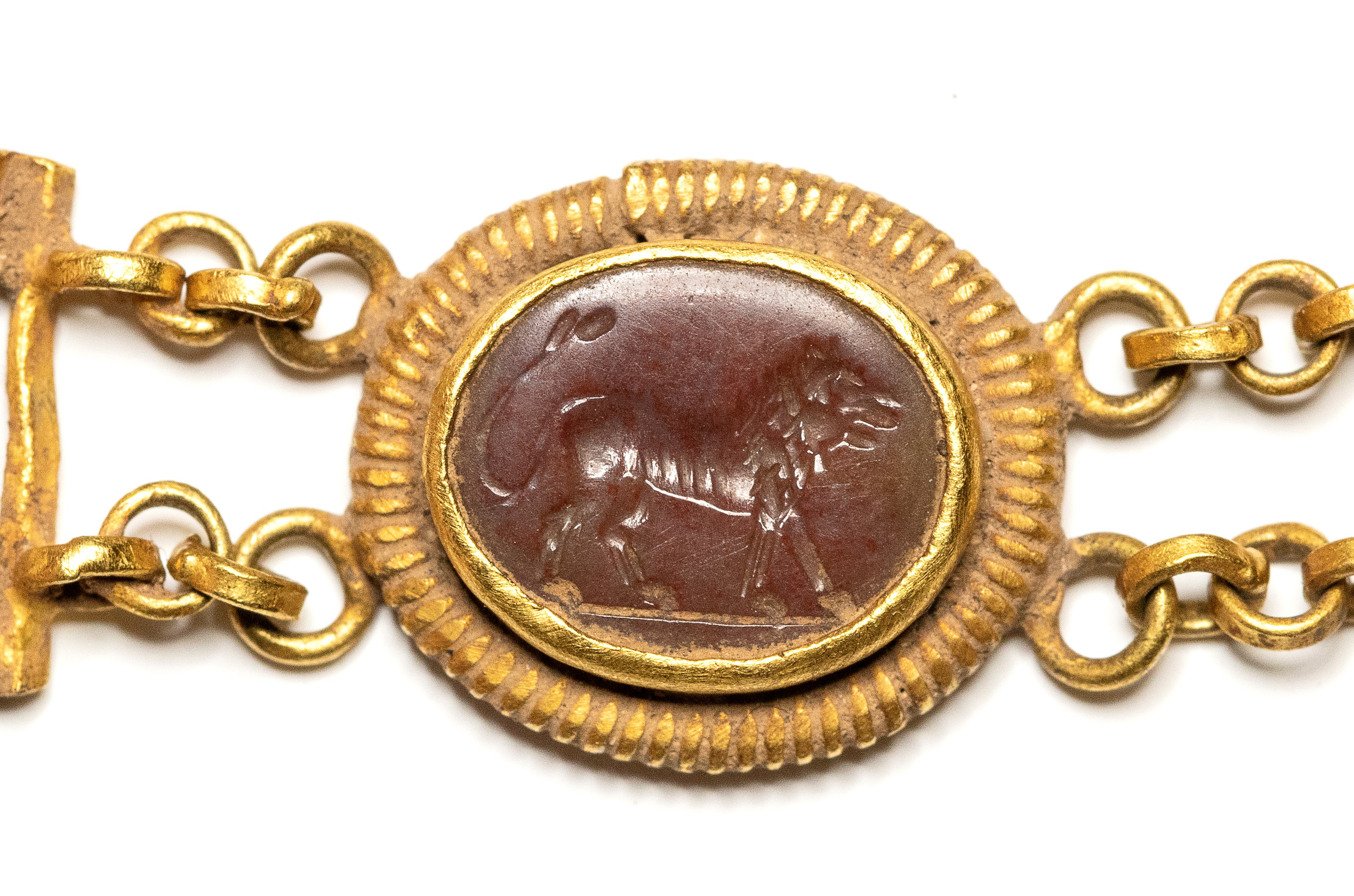 A Roman gold bracelet with six hardstones intaglios. Various subjects.