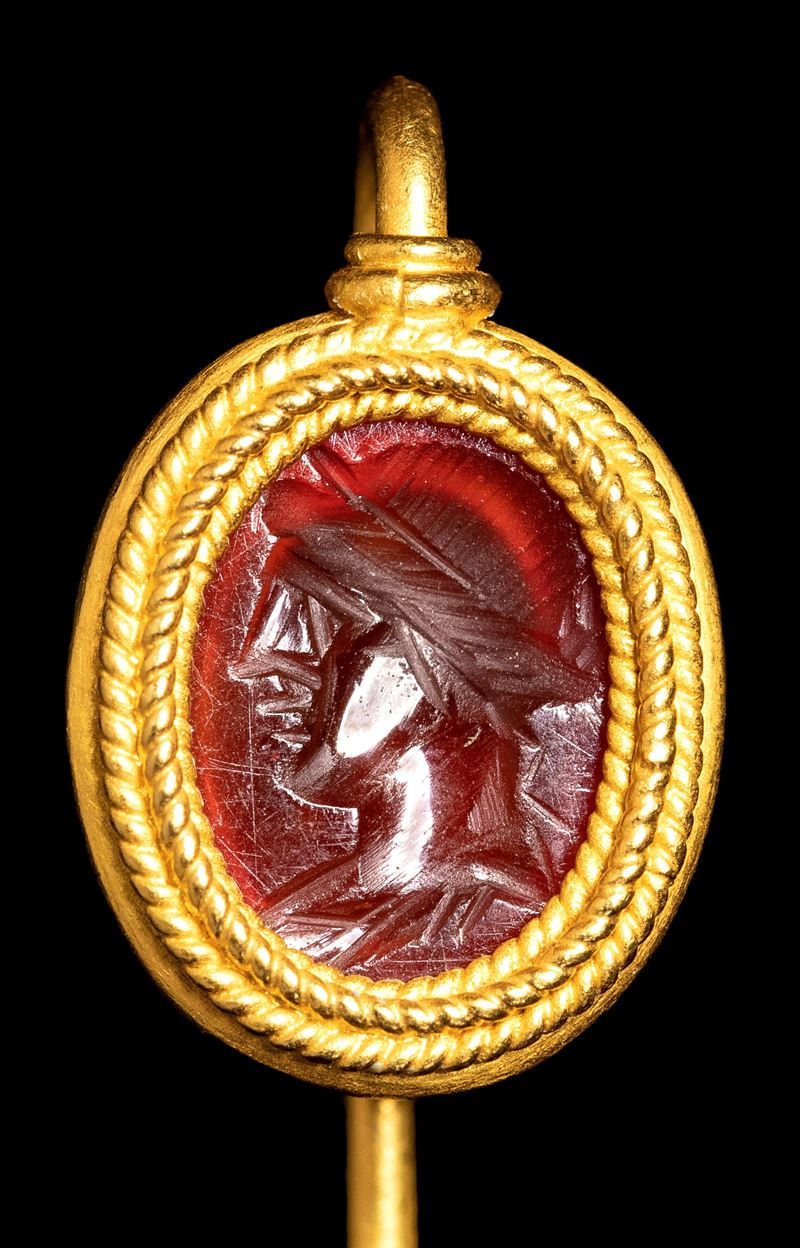 A Roman carnelian intaglio set in a gold stick pin. Apollo.