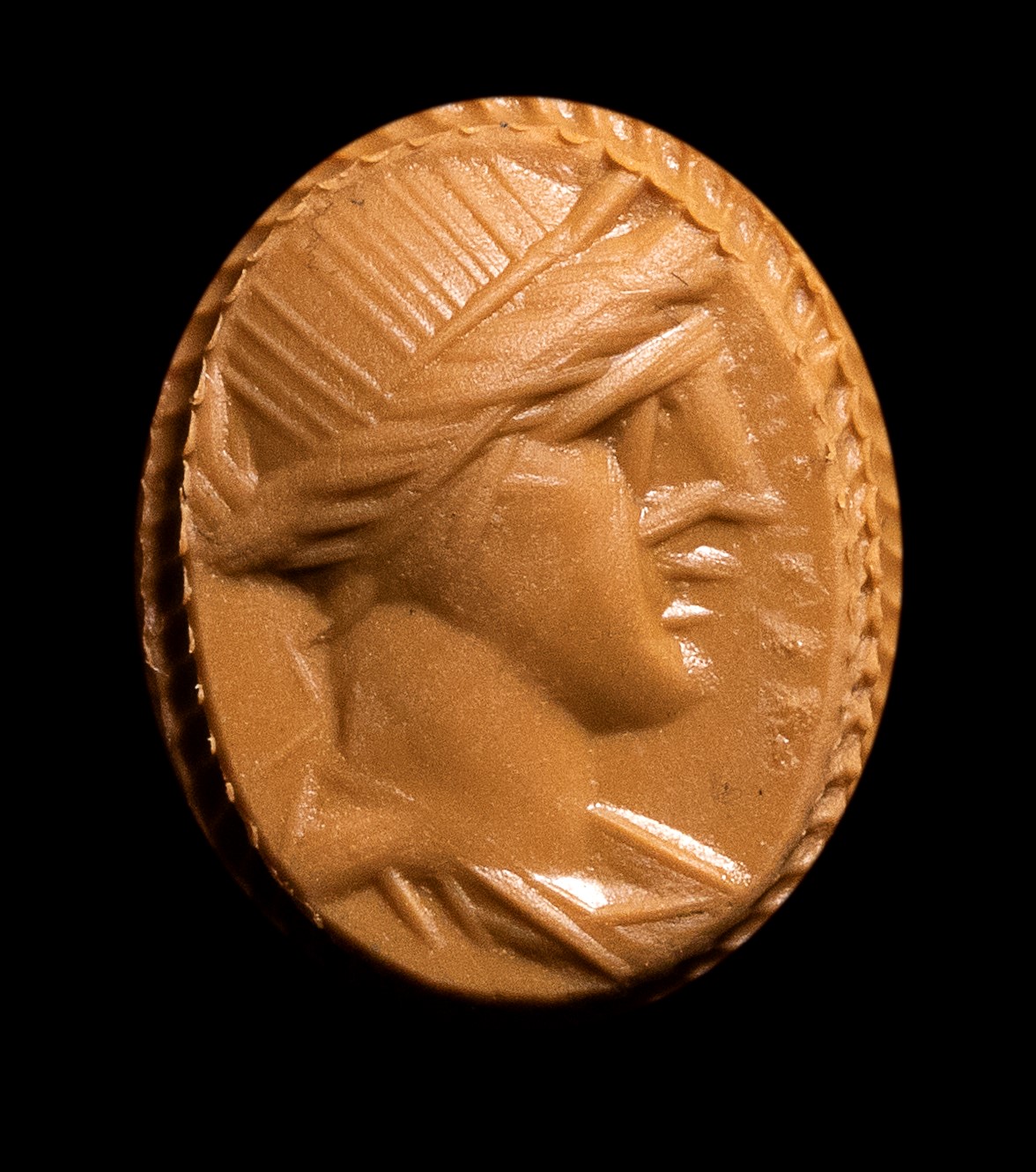 A Roman carnelian intaglio set in a gold stick pin. Apollo.
